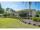 Well-maintained home exterior surrounded by meticulously landscaped gardens and mature trees, showcasing curb appeal at 3452 Forelock Rd, Tarpon Springs, FL 34688