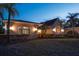 Charming home at twilight, featuring well-maintained landscaping and illuminated details at 3452 Forelock Rd, Tarpon Springs, FL 34688