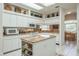 Spacious kitchen with white cabinets, central island, and granite countertops at 3452 Forelock Rd, Tarpon Springs, FL 34688