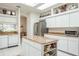 Bright kitchen featuring an island with granite countertop, stainless steel appliances, and a skylight at 3452 Forelock Rd, Tarpon Springs, FL 34688