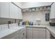 Well-organized laundry room with washer, dryer, sink, ample storage, and countertop space at 3452 Forelock Rd, Tarpon Springs, FL 34688
