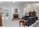 Spacious living room featuring a cozy seating area, marble fireplace, and natural lighting at 3452 Forelock Rd, Tarpon Springs, FL 34688
