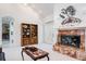Light-filled living room with fireplace, built-in shelving, and view to the outside at 3452 Forelock Rd, Tarpon Springs, FL 34688