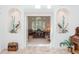 Elegant entrance to an office, featuring a decorative niche, double doors, and a view of the workspace at 3452 Forelock Rd, Tarpon Springs, FL 34688