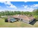 Aerial view of a home with a screened-in pool, a spacious lawn and mature trees creating a private backyard oasis at 3452 Forelock Rd, Tarpon Springs, FL 34688