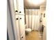 Efficient bathroom space with white cabinets and classic fixtures at 3910 Sarah Dr, Wesley Chapel, FL 33543