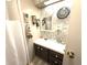 Cozy bathroom with a single vanity and decorative floral wallpaper at 3910 Sarah Dr, Wesley Chapel, FL 33543