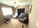 Comfortable bedroom featuring two recliners and a ceiling fan at 3910 Sarah Dr, Wesley Chapel, FL 33543