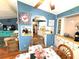 Cozy dining area featuring a glass-top table, complemented by light blue walls and a view into the kitchen at 3910 Sarah Dr, Wesley Chapel, FL 33543