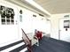 Covered porch area with seating, providing a cozy outdoor space at 3910 Sarah Dr, Wesley Chapel, FL 33543