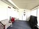 Covered porch area with seating, providing a cozy outdoor space at 3910 Sarah Dr, Wesley Chapel, FL 33543