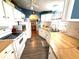 Efficient kitchen with white cabinets, wood countertops, and modern appliances for a bright and functional cooking space at 3910 Sarah Dr, Wesley Chapel, FL 33543