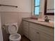 Bathroom showcasing granite countertop vanity with a sink and decorative backsplash at 503 Sunset Rd, Plant City, FL 33563
