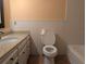 Cozy bathroom featuring a vanity with a sink, a toilet, and a bathtub at 503 Sunset Rd, Plant City, FL 33563