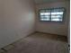 A bright bedroom featuring carpeted floors and a window offering natural light at 503 Sunset Rd, Plant City, FL 33563