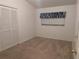 Neutral bedroom features carpet floors, closet, and window, creating a tranquil retreat at 503 Sunset Rd, Plant City, FL 33563