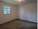 Bright bedroom with a window and neutral carpet provides a serene and comfortable living space at 503 Sunset Rd, Plant City, FL 33563