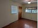 Cozy bedroom featuring hardwood floors, a ceiling fan, and a bright window at 503 Sunset Rd, Plant City, FL 33563