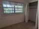 A bedroom with closet, window, and carpet, ready for personalization at 503 Sunset Rd, Plant City, FL 33563