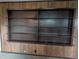 Dark wood built-in shelves with a vintage design against a wood paneled wall offers ample storage at 503 Sunset Rd, Plant City, FL 33563