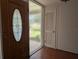 Welcoming entryway with decorative glass door and wood floors offers a charming first impression at 503 Sunset Rd, Plant City, FL 33563