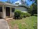 Quaint single story home with an adorned entry door, surrounded by lush landscaping at 503 Sunset Rd, Plant City, FL 33563