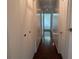Inviting hallway featuring hardwood floors and storage closets at 503 Sunset Rd, Plant City, FL 33563