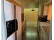 Galley kitchen featuring granite counters, ample cabinet space, and modern appliances at 503 Sunset Rd, Plant City, FL 33563