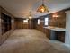 Spacious living room features wood paneling, stained glass light fixtures, and a convenient wet bar at 503 Sunset Rd, Plant City, FL 33563