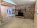 Cozy living room features a brick fireplace and access to outdoor patio at 503 Sunset Rd, Plant City, FL 33563