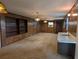Spacious living room features wood paneling, stained glass light fixtures, built-in shelves, and wet bar at 503 Sunset Rd, Plant City, FL 33563