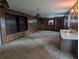 Living room with paneled walls, built-in shelves, and retro light fixtures at 503 Sunset Rd, Plant City, FL 33563