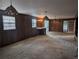 Living room with paneled walls, built-in shelves, and retro light fixtures at 503 Sunset Rd, Plant City, FL 33563