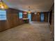 Open concept living room features wood paneling and stained glass light fixtures, perfect for entertaining at 503 Sunset Rd, Plant City, FL 33563