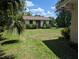 Backyard outbuilding featuring a door, windows and shrubbery at 503 Sunset Rd, Plant City, FL 33563