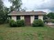 Exterior view of the storage shed featuring double doors, two windows, and minimal landscaping at 503 Sunset Rd, Plant City, FL 33563