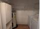 Organized utility closet with water heater, storage, and a washer and dryer at 503 Sunset Rd, Plant City, FL 33563
