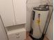 Functional closet space with a water heater and storage cabinets for added convenience at 503 Sunset Rd, Plant City, FL 33563