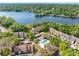 Aerial view of the condos with a pool and lake view surrounded by lush greenery at 5122 Puritan Cir # 5122, Tampa, FL 33617