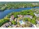 Aerial view of the condos with a pool and lake view surrounded by lush greenery at 5122 Puritan Cir # 5122, Tampa, FL 33617