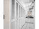 Hallway to bathroom with vanity, mirror, and ample storage cabinets, creating a spa-like retreat at 5122 Puritan Cir # 5122, Tampa, FL 33617