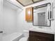 Bathroom with a tiled shower, vanity, and mirror at 5122 Puritan Cir # 5122, Tampa, FL 33617