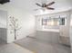 Inviting bedroom with a custom platform bed, ceiling fan, and ample natural light at 5122 Puritan Cir # 5122, Tampa, FL 33617
