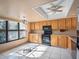 Bright kitchen featuring oak cabinets, tile floor, and ceiling fan at 5122 Puritan Cir # 5122, Tampa, FL 33617