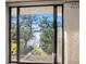 Lake view from a window showing a dock and trees on the water at 5122 Puritan Cir # 5122, Tampa, FL 33617