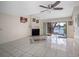 Spacious living room with tile floors, fireplace, and sliding doors to the screened balcony at 5122 Puritan Cir # 5122, Tampa, FL 33617