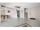 Bright open living room with tile flooring, ceiling fan, staircase, and front door at 5122 Puritan Cir # 5122, Tampa, FL 33617