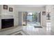 Inviting living room features a fireplace and sliding glass doors with a lake view at 5122 Puritan Cir # 5122, Tampa, FL 33617