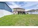 Spacious backyard showcases a well-maintained lawn, a white fence and screened-in patio at 533 Vista Ridge Dr, Ruskin, FL 33570