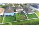Aerial of back of home featuring a large, fenced yard with mature landscaping, a covered patio, and lush greenery at 533 Vista Ridge Dr, Ruskin, FL 33570
